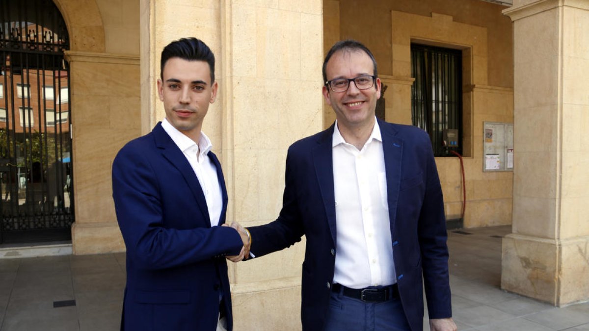 Marc Solsona, de Mollerussa Primer, i Joel Bastons, del PSC, encaixant les mans després de firmar el pacte per un govern en minoria a Mollerussa.