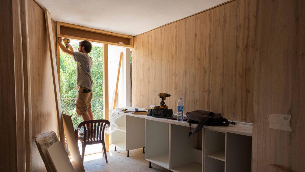 Un joven trabajando en la rehabilitación del antiguo cuartel de la Guardia Civil de Agramunt en viviendas sociales dentro del proyecto Vibra.