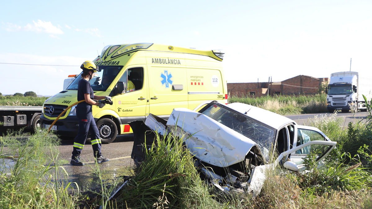 Una bombera y efectivos del SEM trabajando ayer en el choque en la N-IIa en Lleida. - MAGDALENA ALTISENT