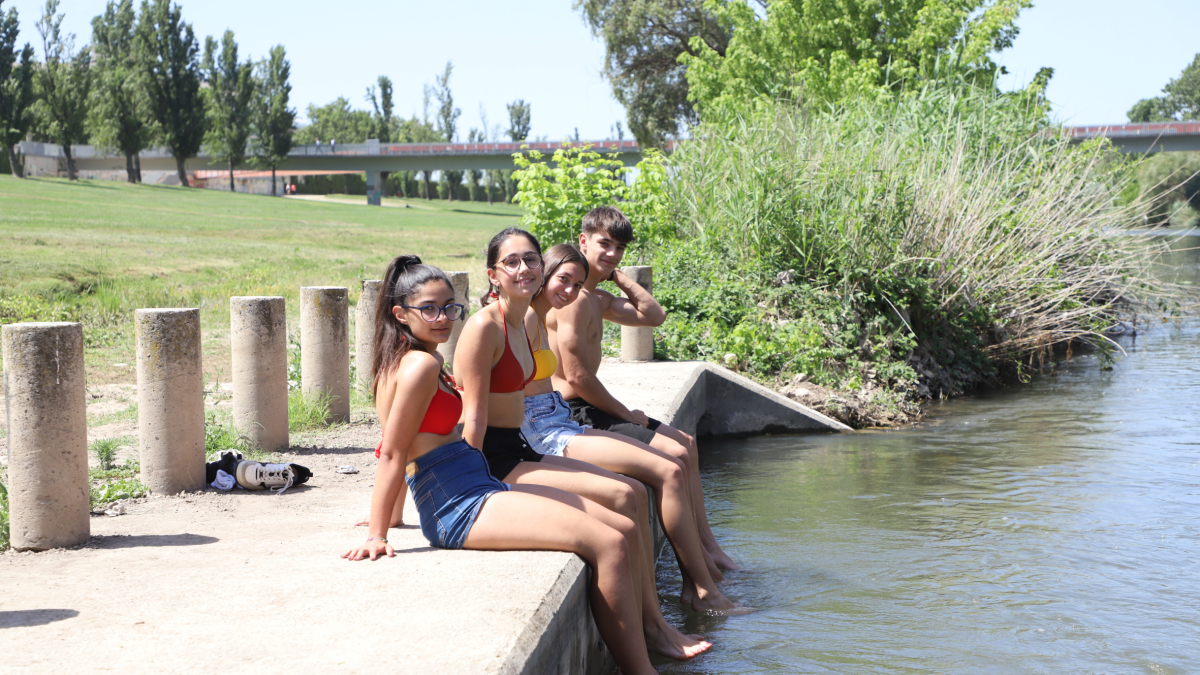 Un grup de joves de Lleida mullant-se els peus per refrescar-se.