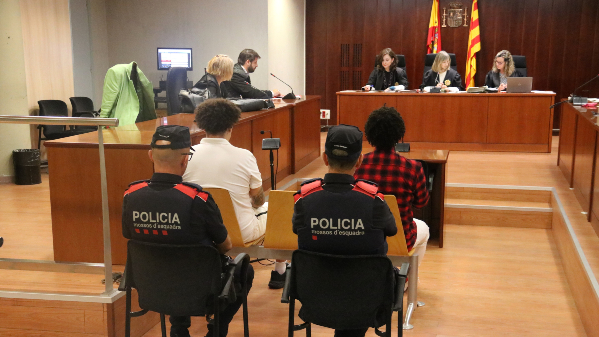 Els dos acusats, custodiats per dos agents dels Mossos, aquest dimecres a l'Audiència de Lleida.