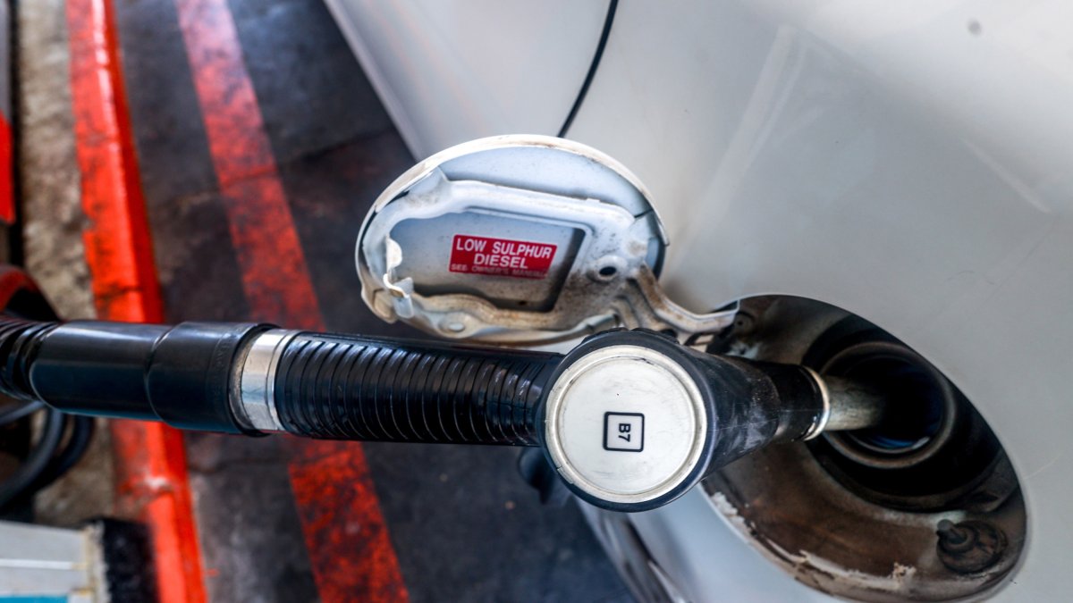 Un coche repostando en una gasolinera. 