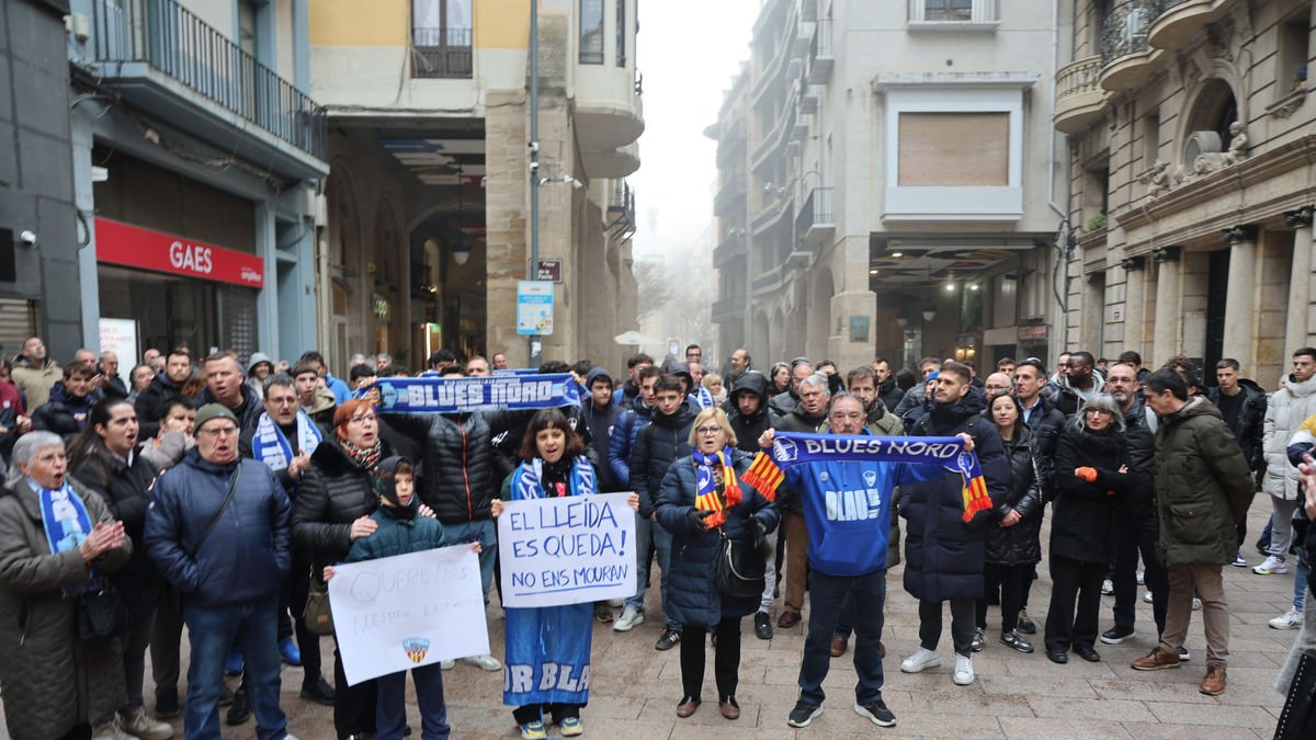 Aficionados y peñistas del Lleida ayer durante la protesta delante de la Paeria. - AMADO FORROLLA