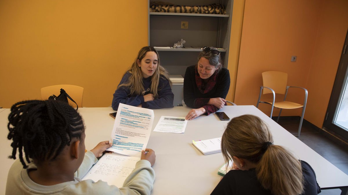 La monitora i la tècnica del Pla Educatiu d’Entorn, amb dos estudiants al Refugi Estudiantil. - CARMINA MARSIÑACH