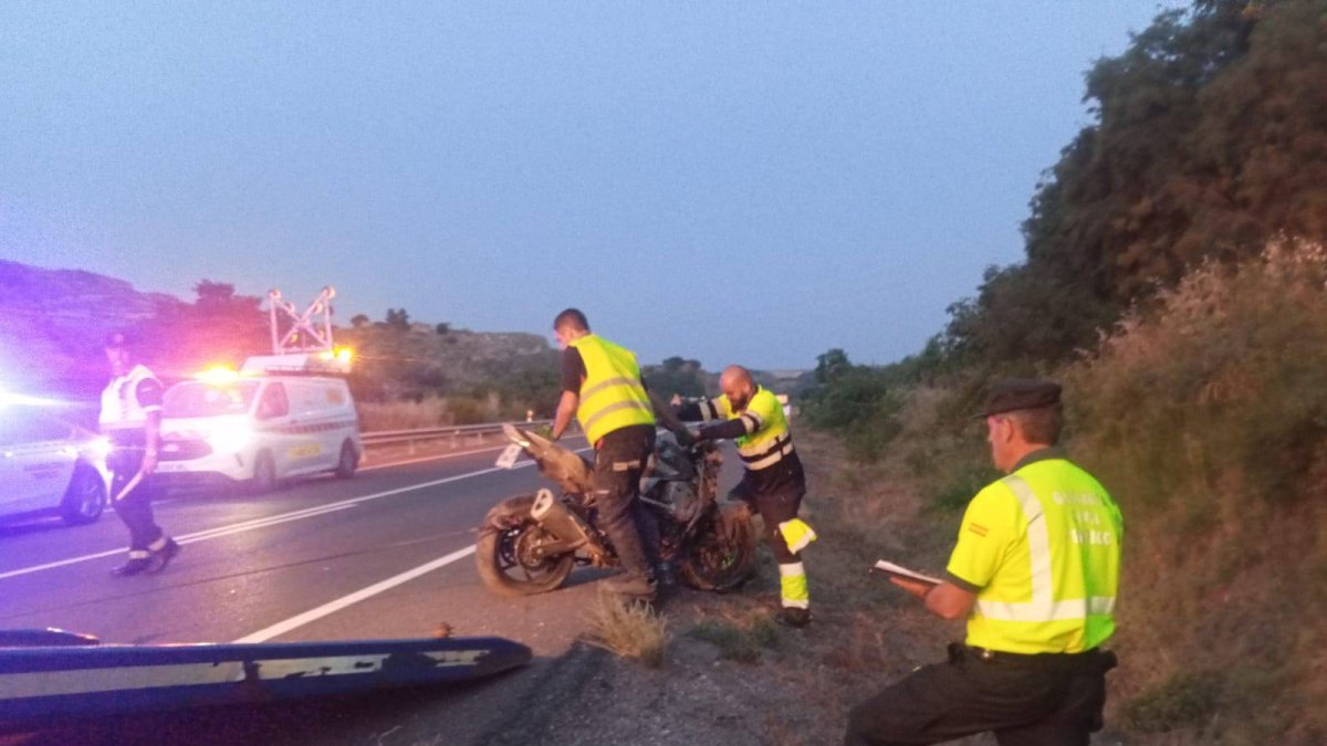 Agents de la Guàrdia Civil retiren la moto de l’home que va morir.