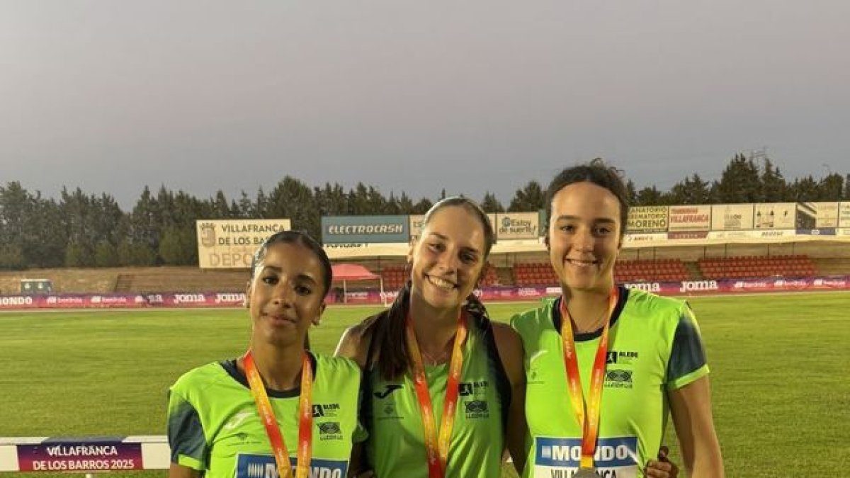 Las tres medallistas del Lleida UA posan en la pista de atletismo de Villafranca de los Barros.
