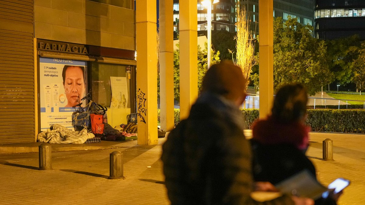 Imagen de archivo de un grupo de voluntarios observan a unas personas durmiendo en la calle en el marco del recuento de Raíces en Barcelona.