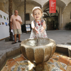 Una niña se refrescaba ayer de las altas temperaturas en Lleida en la fuente del IEI.