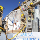 Bombers treballant en l'incendi de la decoració d'una carrossa a Balaguer.
