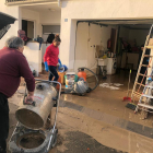 Vecinos limpian su casa este viernes en Agramunt después de la riada del Sió.