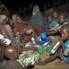 Una família nigeriana menja la seva ració d'aliments en un campament de desplaçats interns a Maiduguri