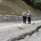 Joan Jansat y Loli Cacereño muestran el punto donde se registraron los aludes y la carretera ha empezado a resquebrajarse y hundirse.