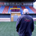 Un membre del club de futbol de Camarles mirant el crespó negre col·locat a les grades com a mostra de condol per la mort de tres joves del municipi, jugadors de l'entitat, en un accident de trànsit